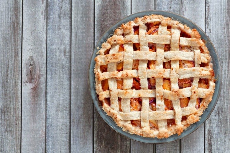 Rustic homemade peach pie, above view on wood