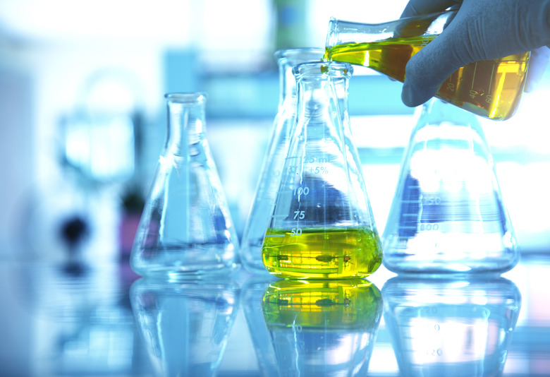 hand of scientist with flask glassware in science laboratory