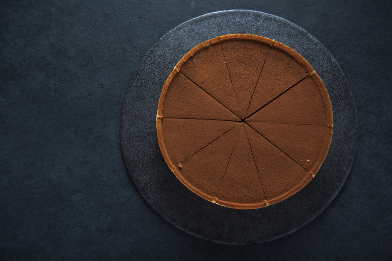 Sliced chocolate tort on dark background