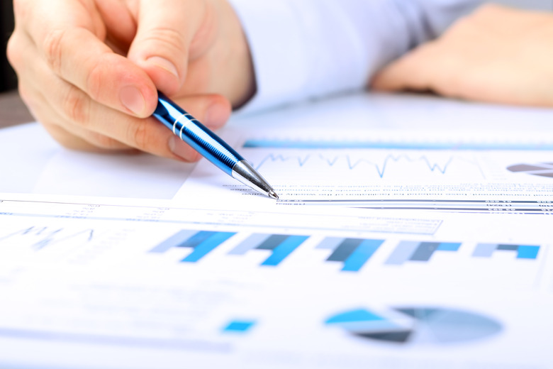 Close-up Of Businessman Analyzing Graph in the office