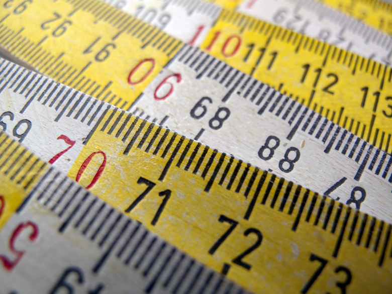 Close-up of wooden white and yellow ruler