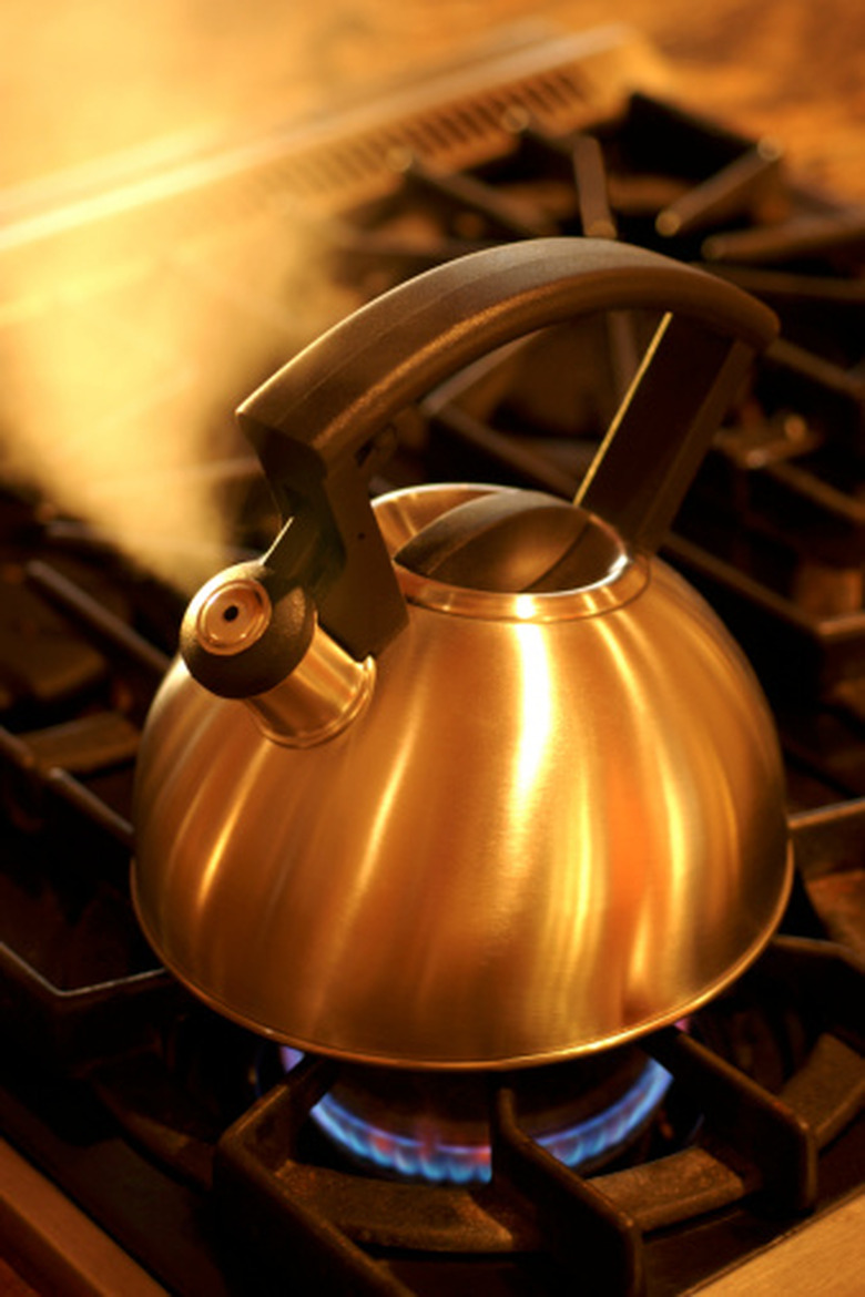 A steaming teapot on a stove