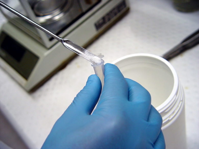 Wearing gloves and weighing a sample