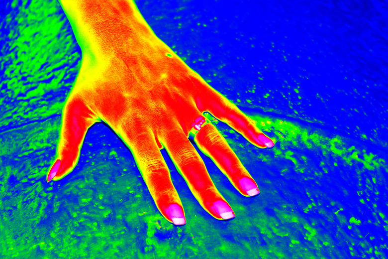 Infrared thermovision image of woman hand over the cold water