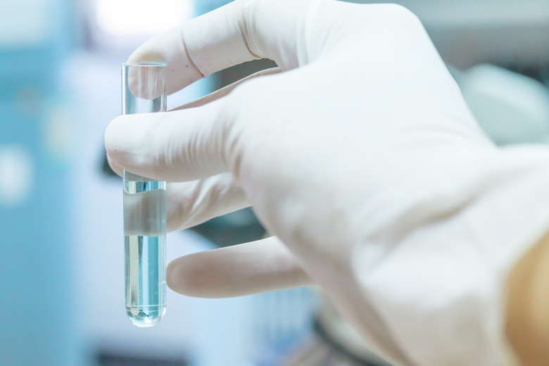 Test tube in scientist hand in laboratory