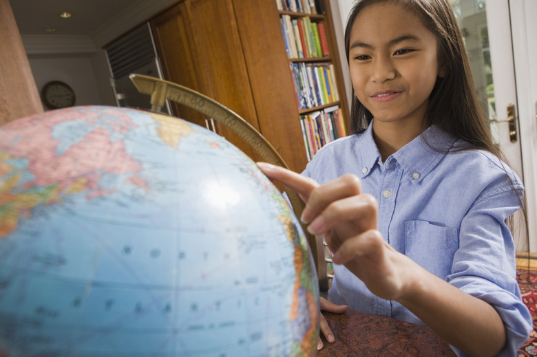 Girl looking at a globe