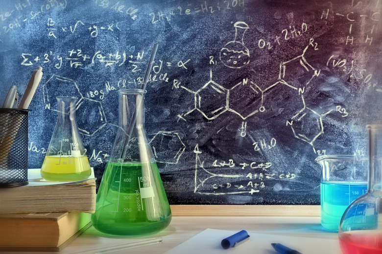 Classroom desk and drawn blackboard of chemistry teaching general view