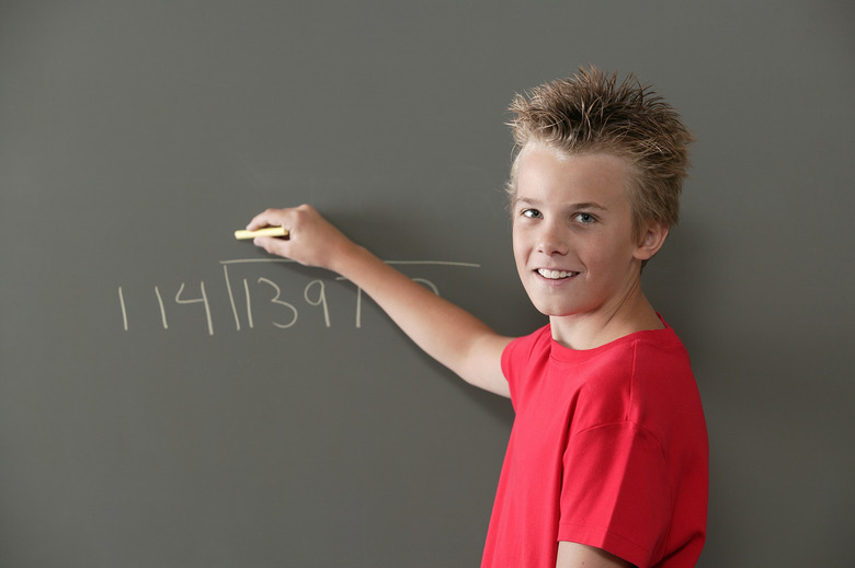 Boy writing on blackboard