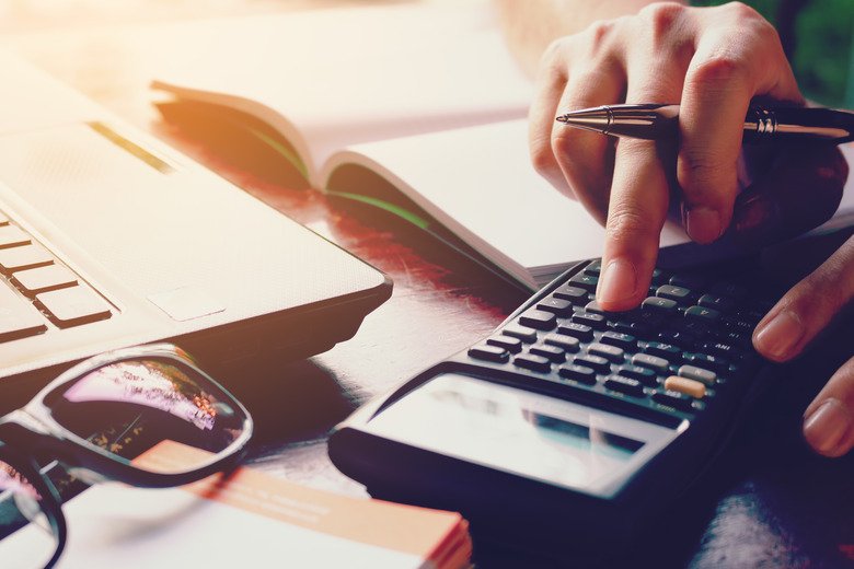 Close up woman doing finance with calculate expenses.