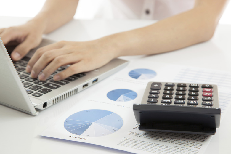 woman hand on laptop with business report