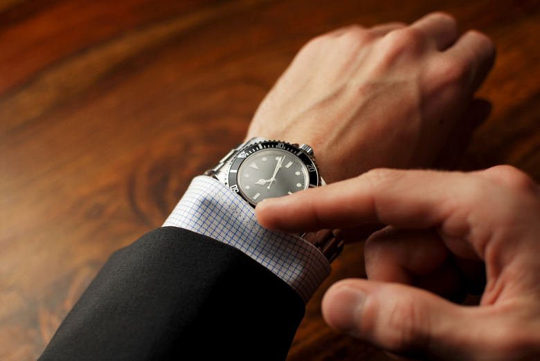 Well-dressed man checking the time on his wristwatch