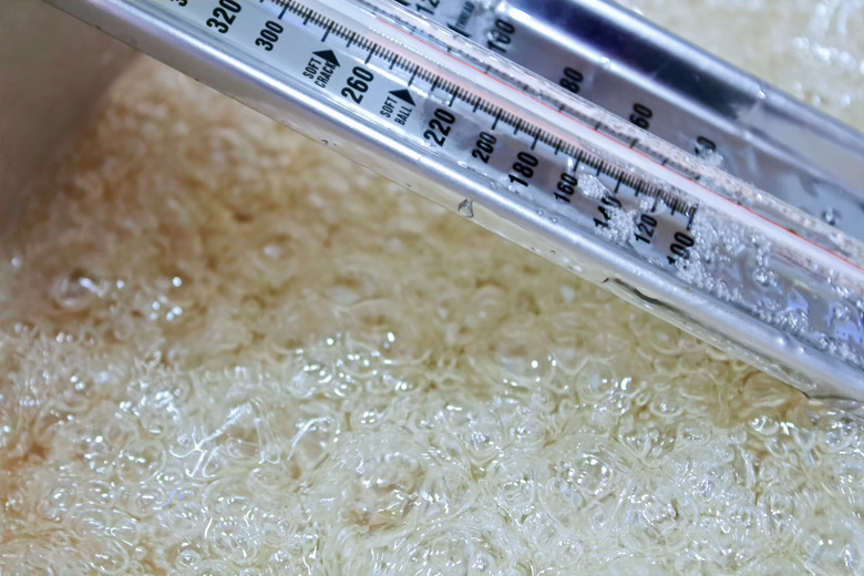 Side view of a candy thermometer as liquid boils