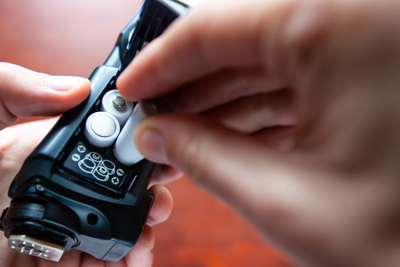 Replacing the AA battery in the on-camera flash