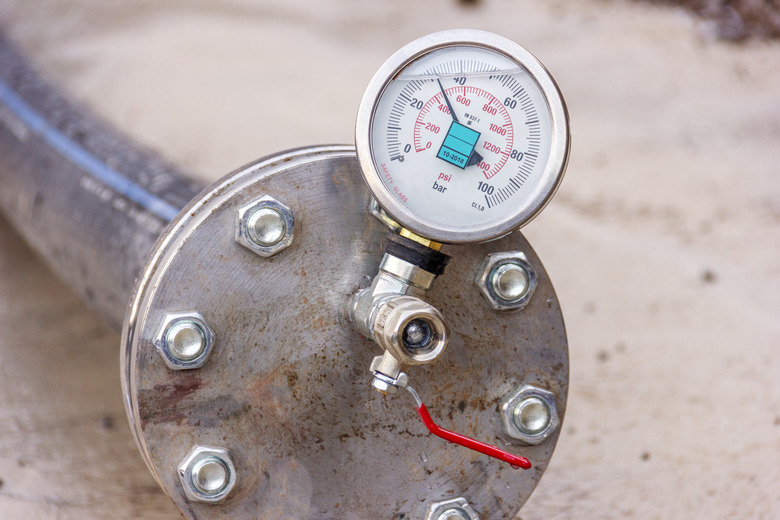 View of the hydrostatic testing of polyethylene pipeline and manometer (pressure gauge). EN 837-1 is a standard to produce for manometer. Cl 1,0 is a class of gauge. Bar (psi) is pressure unit.