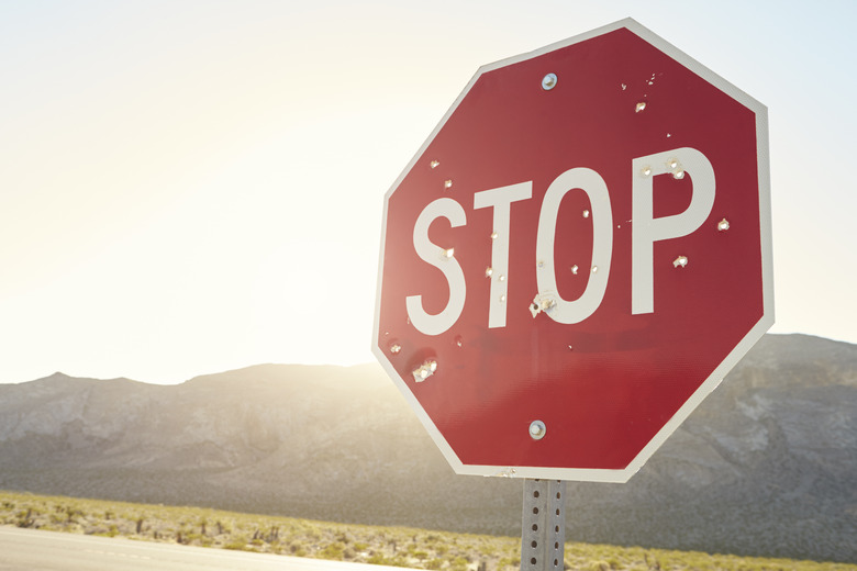 Stop Traffic Sign With Bullet Holes On Country Road