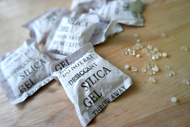 Silica gel packets on a wooden surface