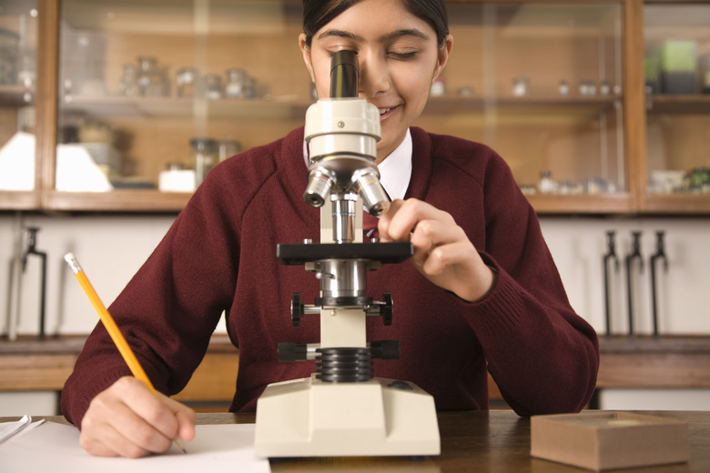 Science student using microscope