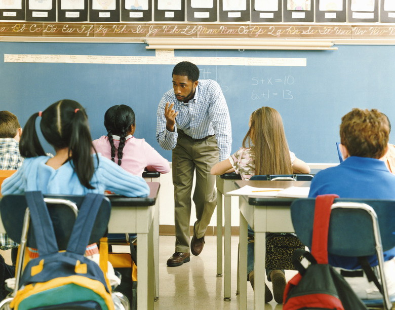 Teacher Answering a Girl in a Primary School Class