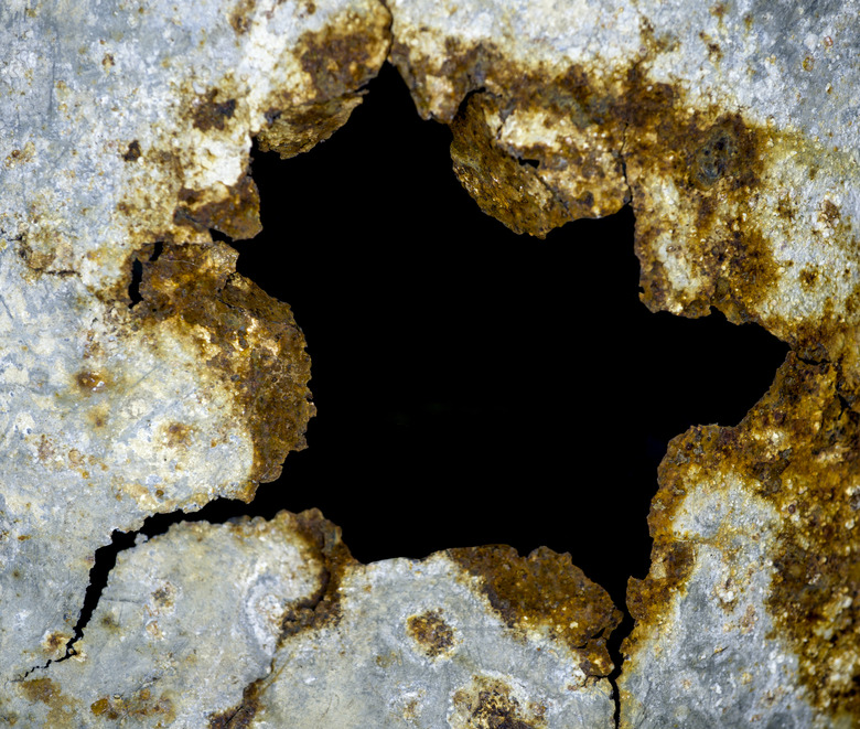 Rusty metal texture with hole isolated on black