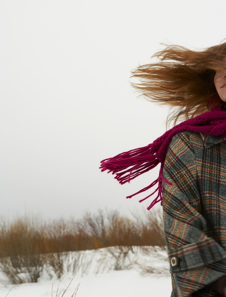 Young woman standing in snow