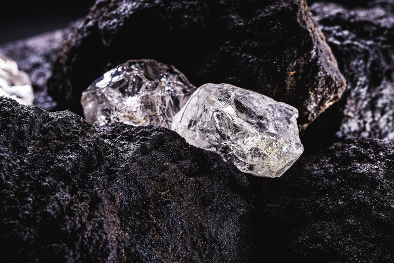 Rough diamond, precious stone in mines. Concept of mining and extraction of rare ores.