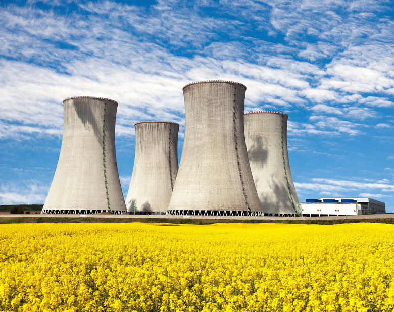 Nuclear power plant Dukovany with golden glowering field of rapeseed