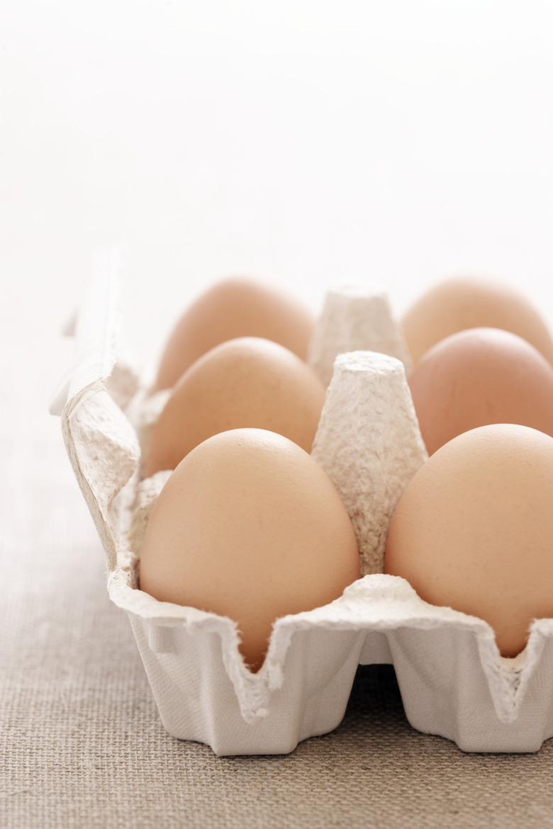 Six eggs in cardboard egg carton, close-up