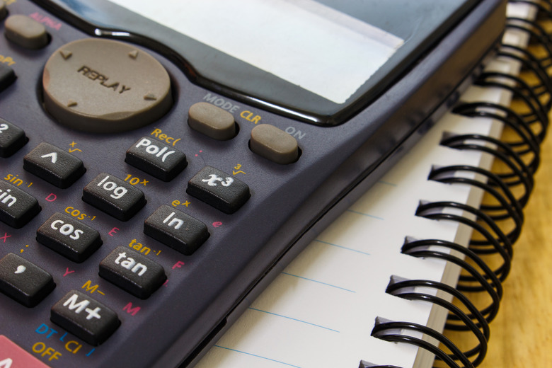 handheld calculator on a sheet of paper notebook