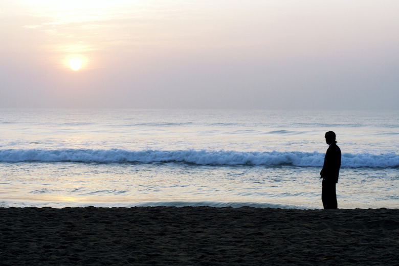 Silhouette of a man standing in a beach