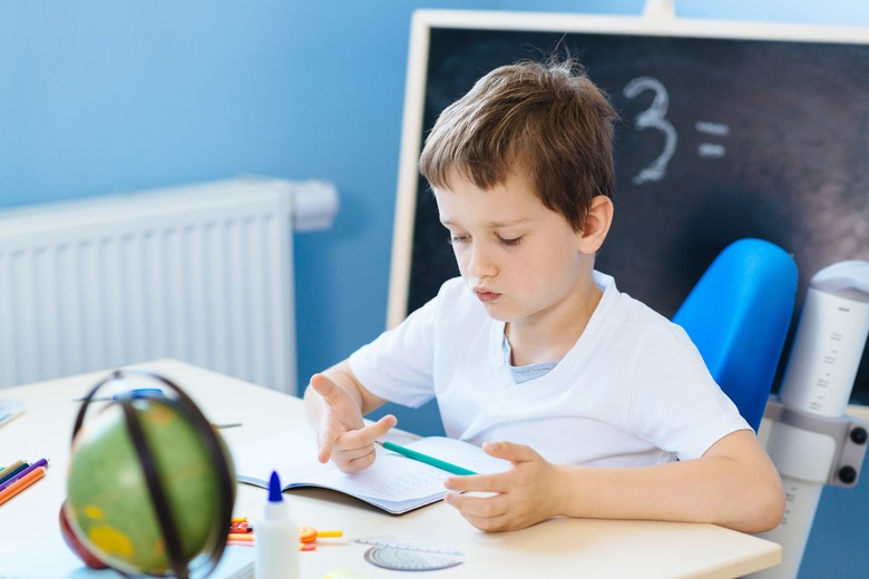 Seven years old boy, counting on fingers