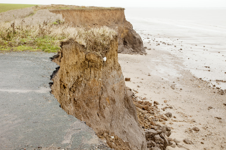 Close-up of a coastal road destroyed over time by erosion