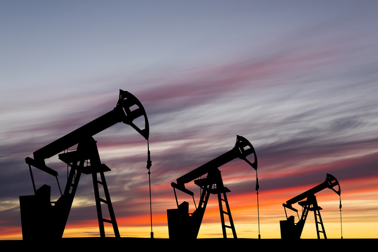 Oil pump on a sunset background. World Oil Industry