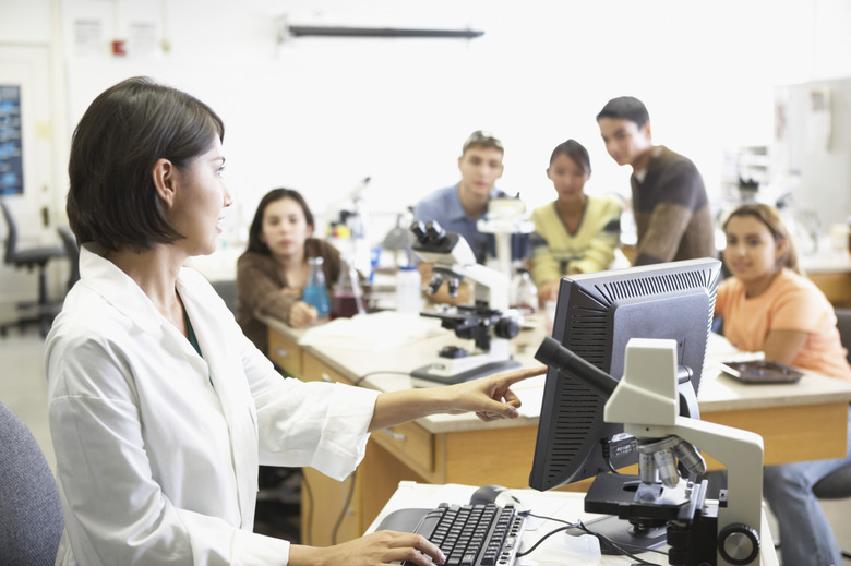 Side profile of a lab technician in front of a computer monitor