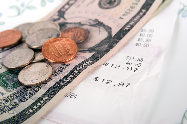 Restaurant bill with dollar bills on a plate and receipt