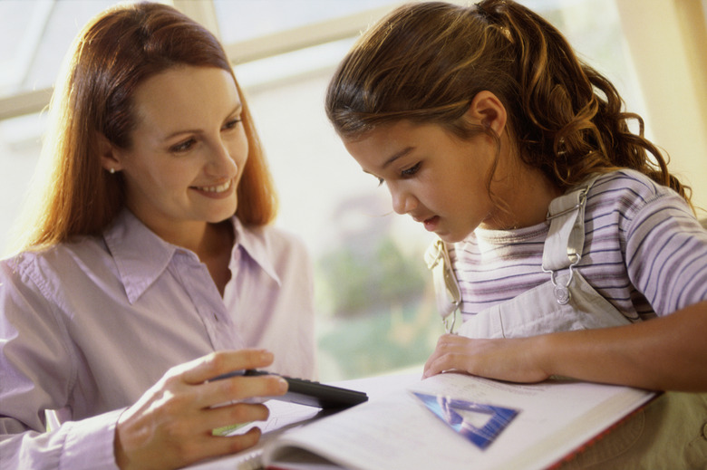 Mother helping her daughter with math homework