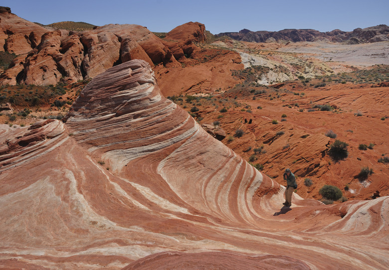 Man Taking a Photo of the Fire Wave Sandstone Formation