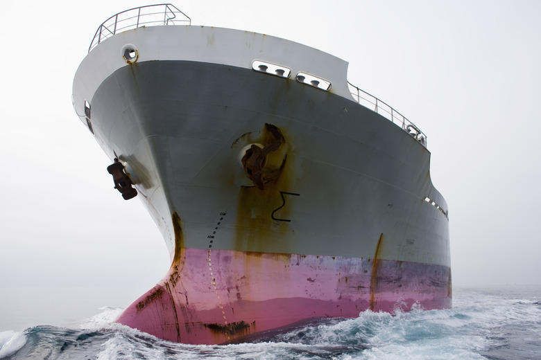 Bow of a pink and grey cargo ship.