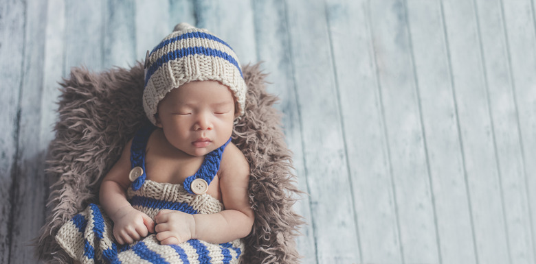 Adorable newborn baby sleeping in cozy room.