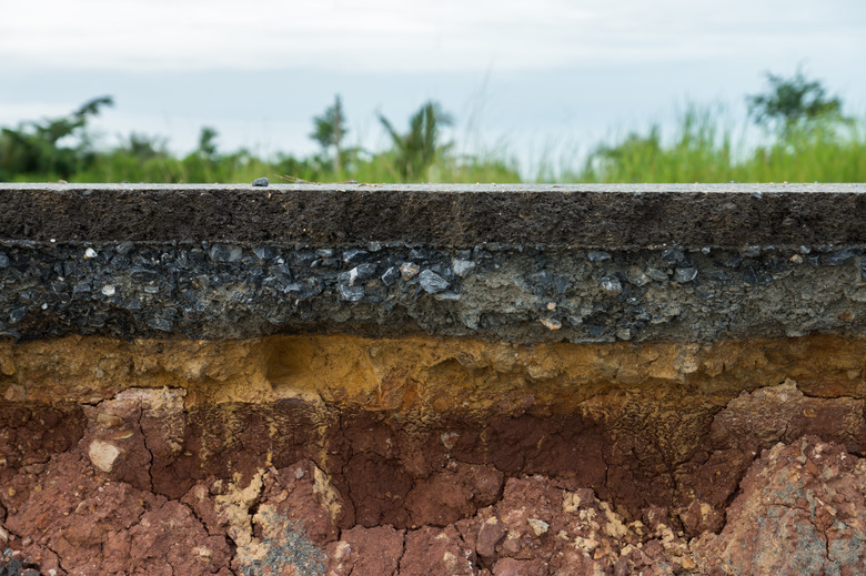 The layer of asphalt road with soil and rock.