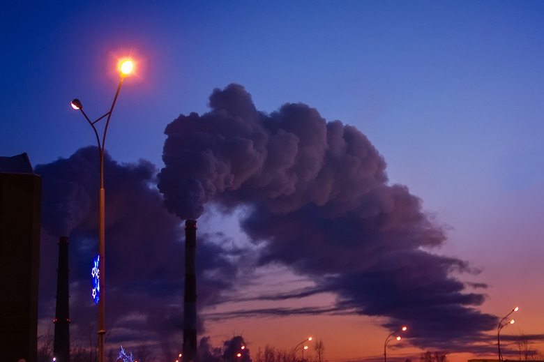 pipe factory smoke emission on the background of the city in the evening