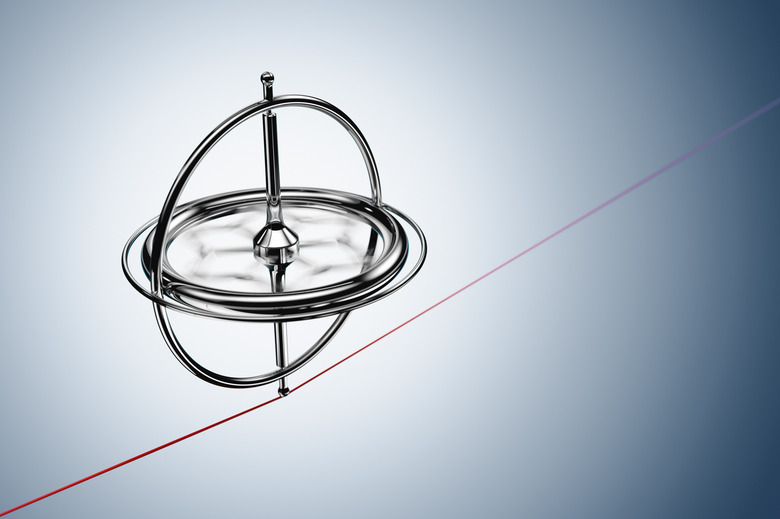 Spinning gyroscope, balancing on a red cable