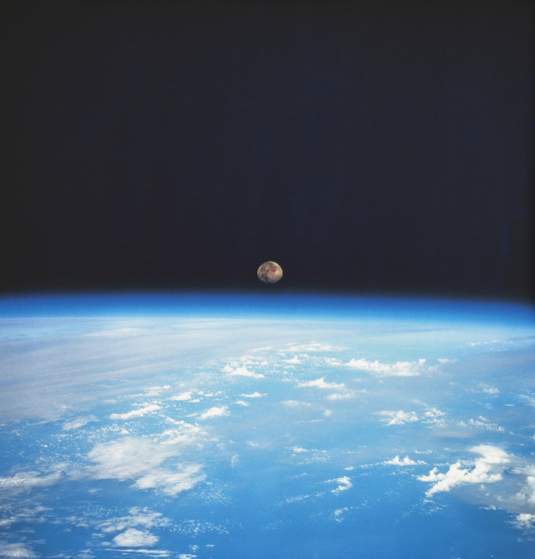 view from space of the earths surface with the moon on the horizon