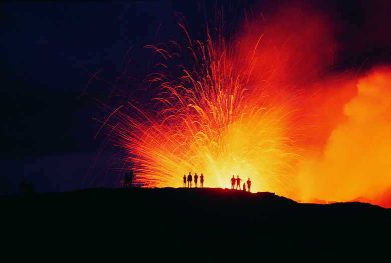 People Standing on the Edge of an Erupting Crater