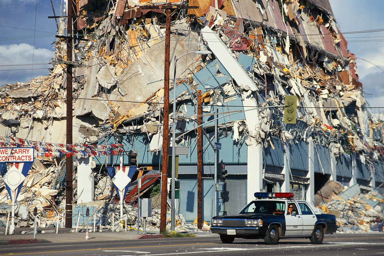 Collapsed building with police car on patrol