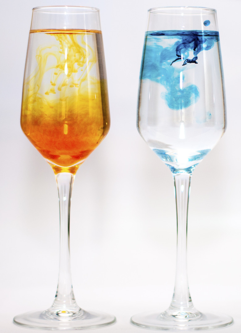 Two glasses filled with water and food colourings