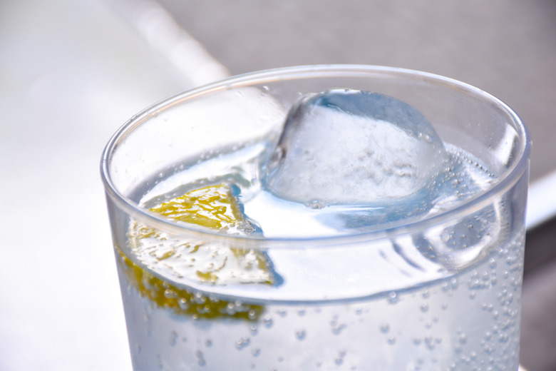 Glass of soda with lemon and ice, closeup