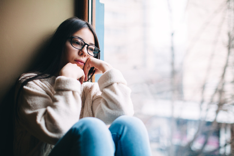 sad girl looking out the window