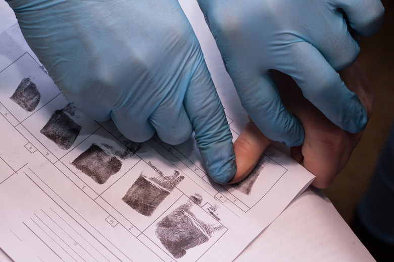 Expert takes a fingerprint of the suspect