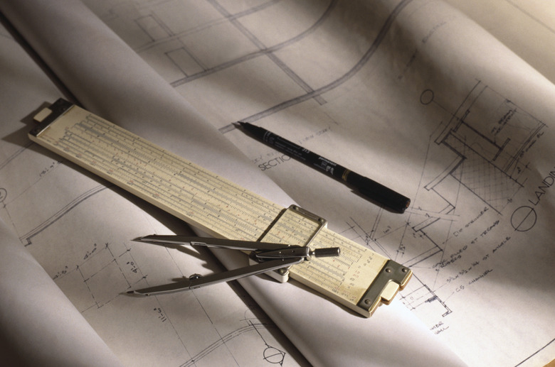 Compass and slide rule on blueprints