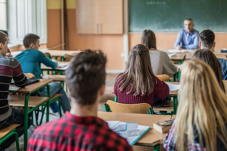 Rear view of high school students attending a class.